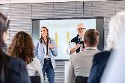 ALTE STADTKASSE - Ihr Raum für Workspaces | Meetings | Events - Ein professionell ausgestatteter Konferenzraum in der Alten Stadtkasse Oldenburg, der sich ideal für Schulungen, Vorträge und Präsentationen eignet. Auf dem Bild halten zwei Vortragende eine 