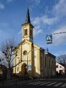 Evangelische Kirche Nieder-Olm - Evangelische Kirchengemeinde Nieder-Olm / Sörgenloch - Die kleine klassizistische Kirche wird durch die Glasfenster des Marburger Künstlers Erhardt Klonk in ein besonderes Licht gerückt. Der Brunnen auf dem Kirchplatz und 