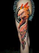Inklabs Tattoo Studio - Halle - ein großer bunter Phoenix auf der seite des Oberschenkels. Der Kopf und ein Flügel ist angebildet, leuchtende rot Töne und ein wenig schwarz ist dabei.