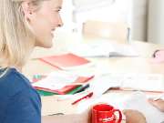 Studienkreis Nachhilfe Bad Nauheim - Nachhilfelehrerin sitzt am Tisch mit Lernmaterialien.